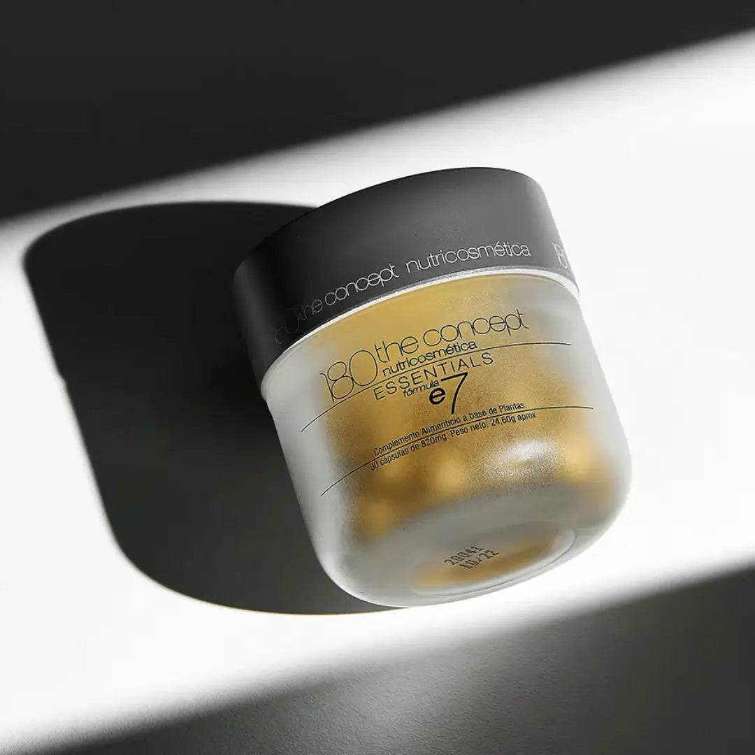 Jar of 180 The Concept Essentials E7 capsules in dramatic lighting, enhancing vitality and skin health.