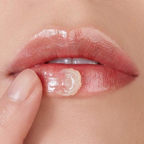 Close-up of a woman applying lip balm, illustrating lip care routine for soft and hydrated lips.