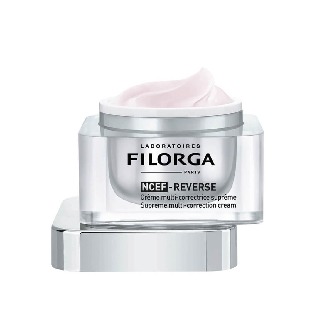 Filorga NCEF-Reverse cream jar open showing pink moisturizer, emphasizing skin rejuvenation with a blend of age-defying ingredients.