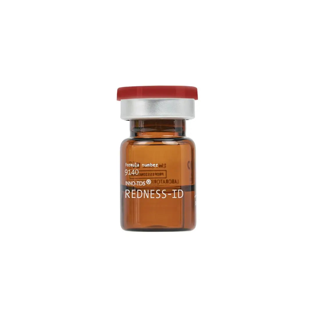 Brown vial of INNO-TDS Redness ID, a product for calming sensitive skin and reducing redness, with a red cap and labeled 'Redness-ID