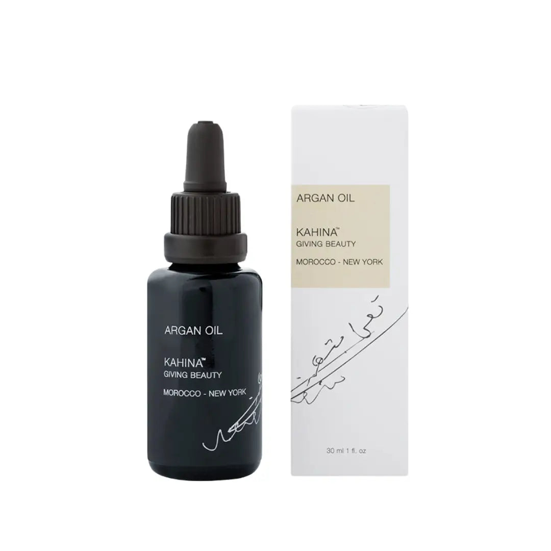 Kahina Argan Oil bottle alongside its box, highlighting the product's elegant packaging and natural ingredients for enhancing skin and hair health.