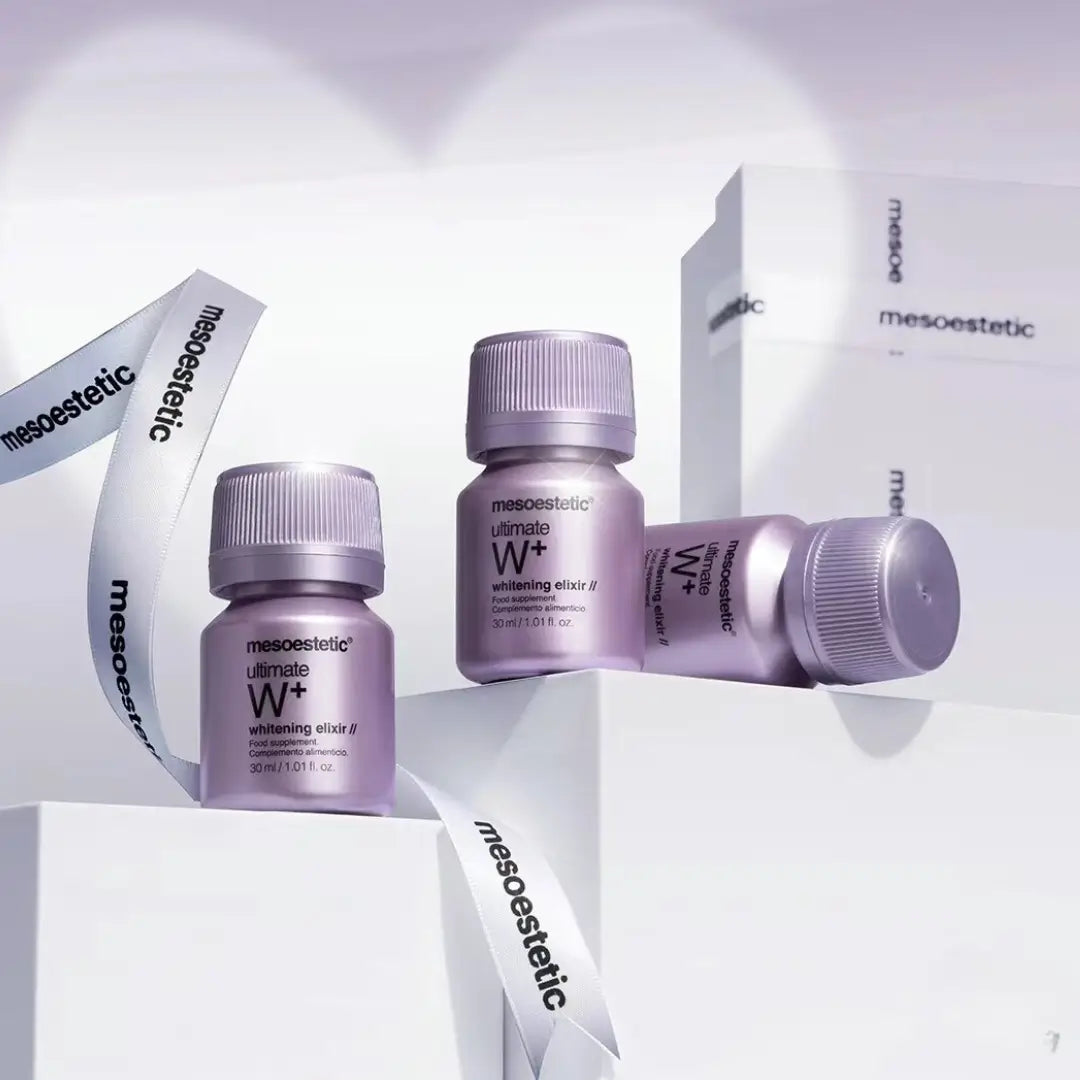 Several 30ml vials of Mesoestetic Ultimate W+ Whitening Elixir are displayed, highlighting the dietary supplement for skin health.