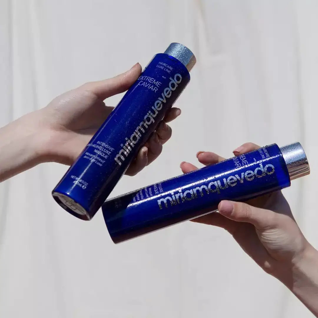 Hands holding blue bottles of MiriamQuevedo Extreme Caviar Intensive Anti-aging Luxe Masque, 250ml.