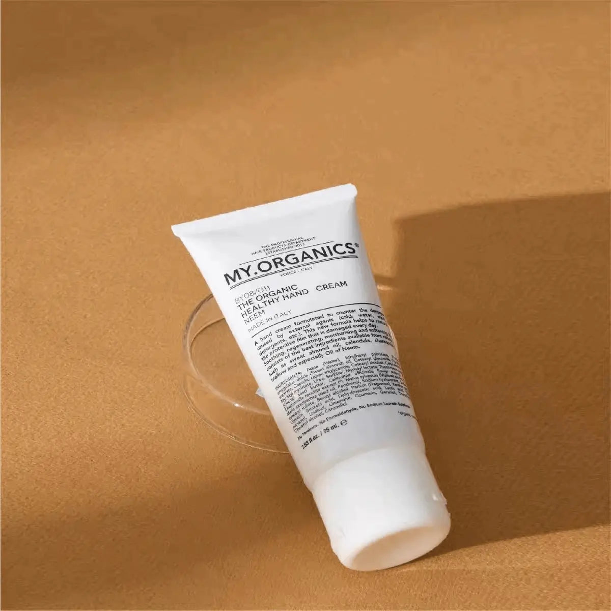 75ml white tube of My Organics Healthy Hands Cream lying on a brown surface, soothing and moisturizing for daily hand care.