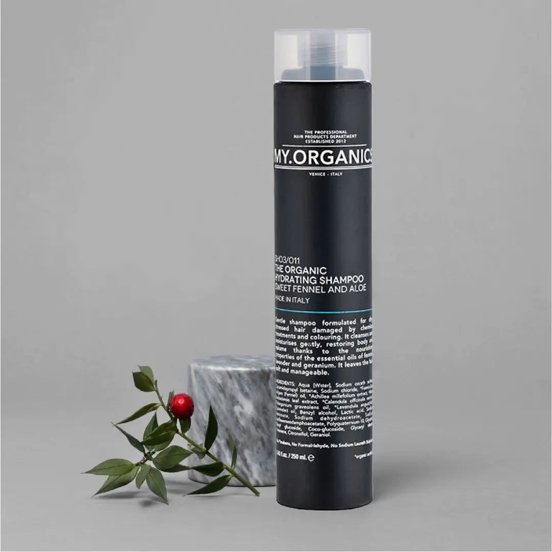 My Organics Hydrating Shampoo, 250ml black bottle with clear cap, displayed with marble block and greenery, for dry, damaged hair.