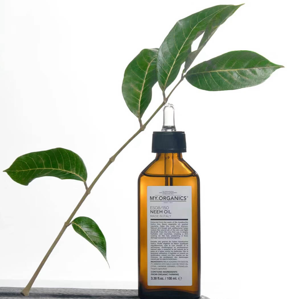 My Organics Neem Oil bottle with green leaves, highlighting its natural, therapeutic properties.