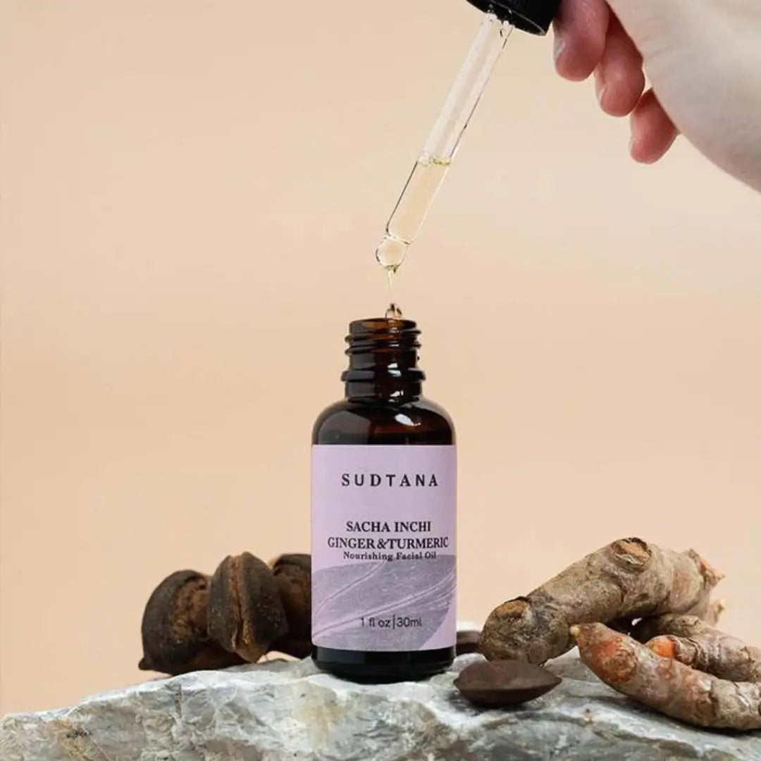 Hand dispensing Sudtana facial oil over rock surface, highlighting its natural, nourishing properties.