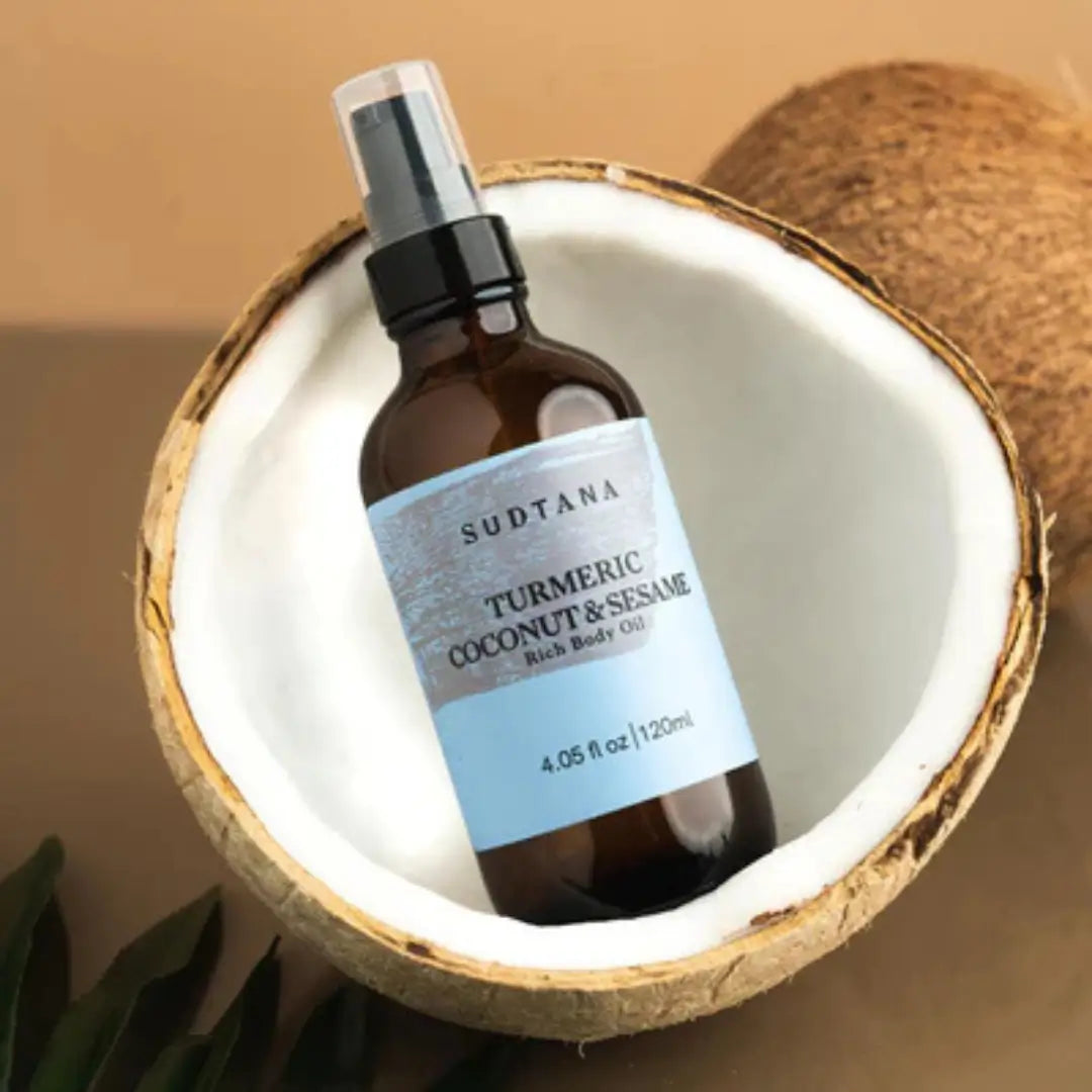 Sudtana body oil in coconut shell, featuring natural ingredients, ideal for skin nourishment.