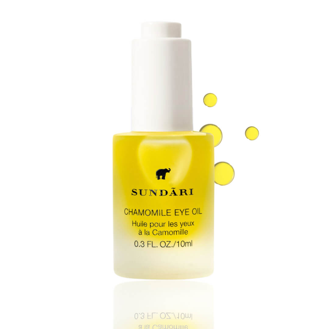 Bright yellow bottle of Sundari Chamomile Eye Oil with droplets, for soothing eye care.