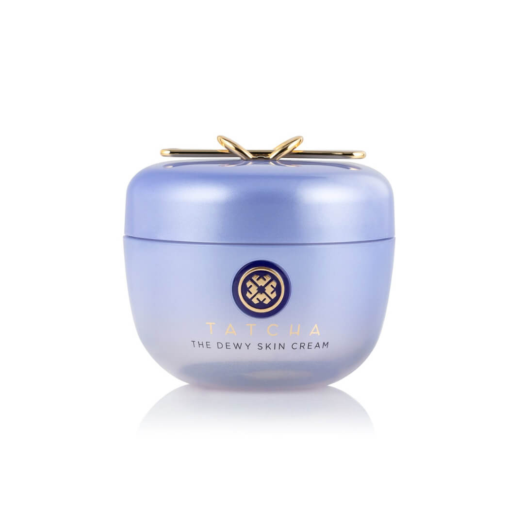 Elegant lavender jar of Tatcha The Dewy Skin Cream, featuring a gold spatula integrated in the lid for precise application.