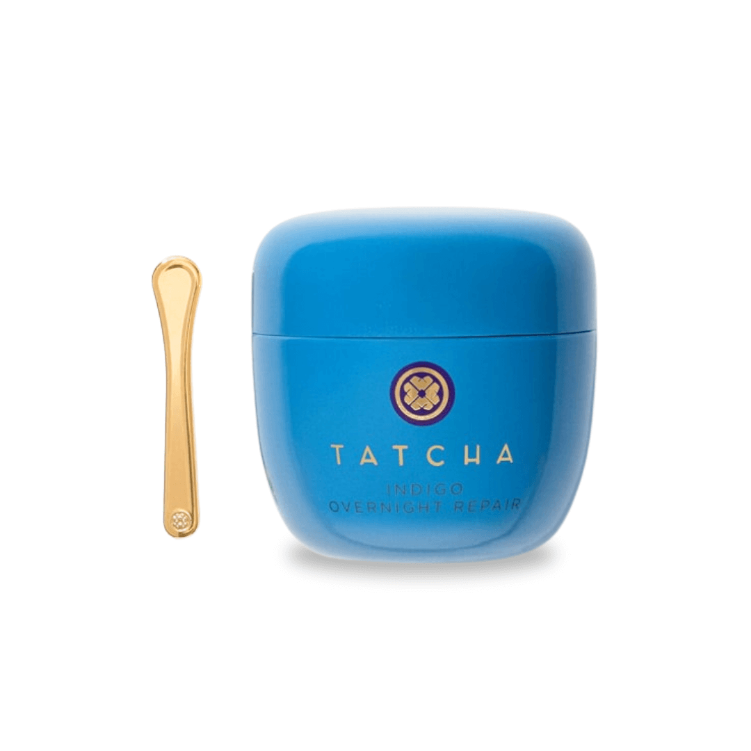 Tatcha Indigo Overnight Repair cream in blue container with gold spatula, designed for soothing skin.