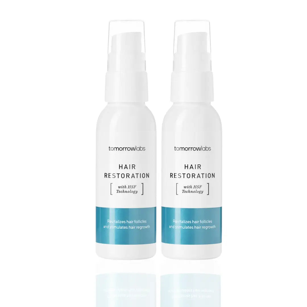 Two 50ml bottles of Tomorrowlabs Hair Restoration Liquid, offering a total of 100ml to promote thicker, stronger hair with long-term use.