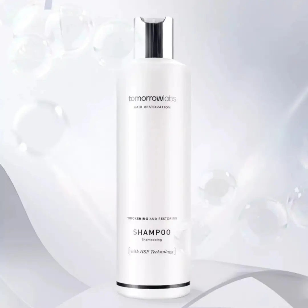 Close-up of Tomorrowlabs Thickening And Restoring Shampoo 250ML bottle, white with black text.